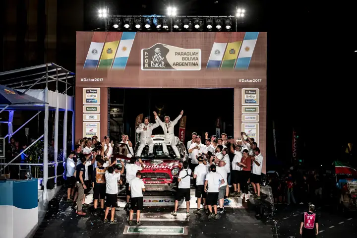 Dakar Rally 2017: team celebrating on car at finish podium