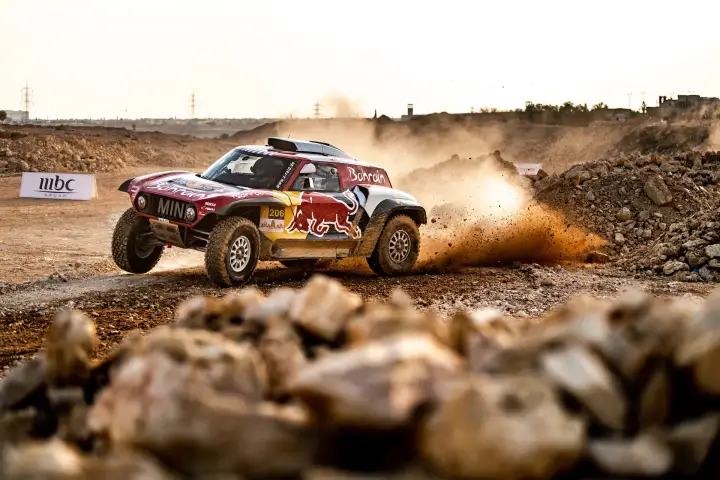 Riyadh Rally 2019: red Mini racing across rocky Riyadh desert terrain